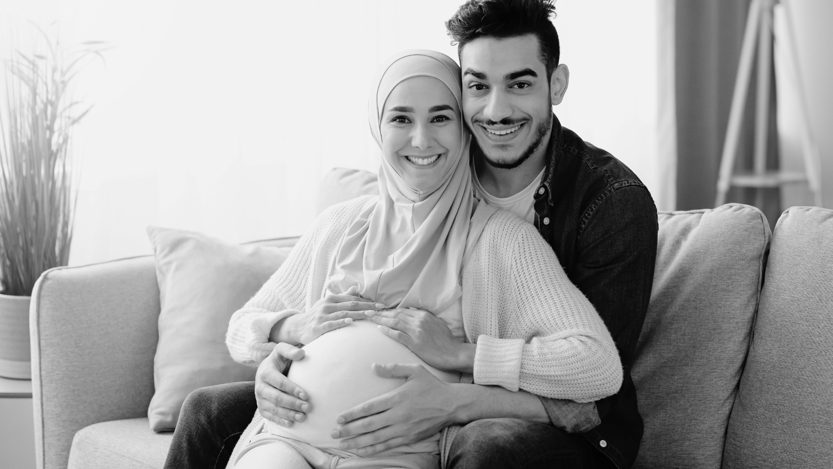 Pregnant Couple sitting on couch